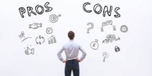 image shown Man analyzing pros and cons illustrated on a whiteboard